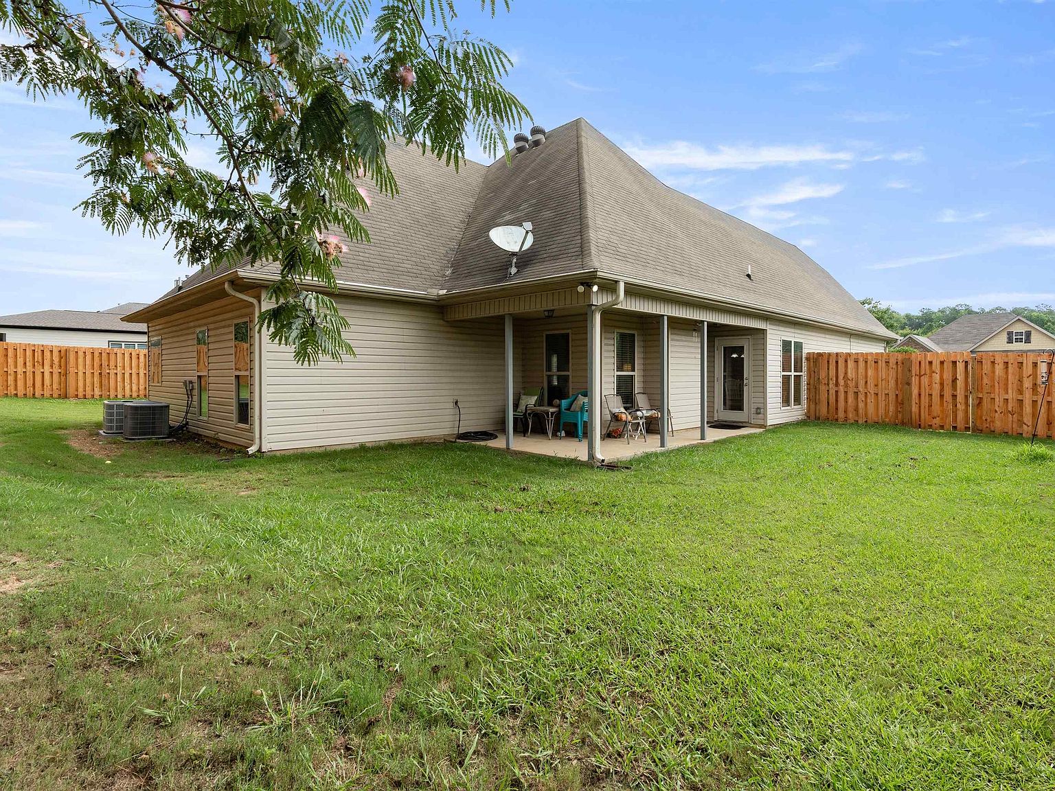 Covered patio and fenced backyard
